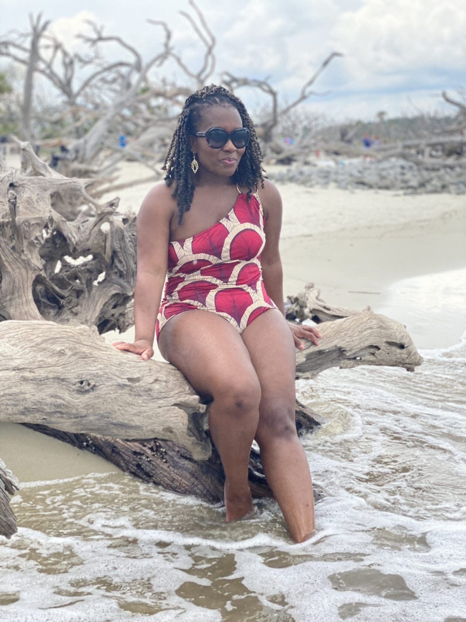 African American woman with crochet braids on Driftwood beach in Vogue 9192 swim suit