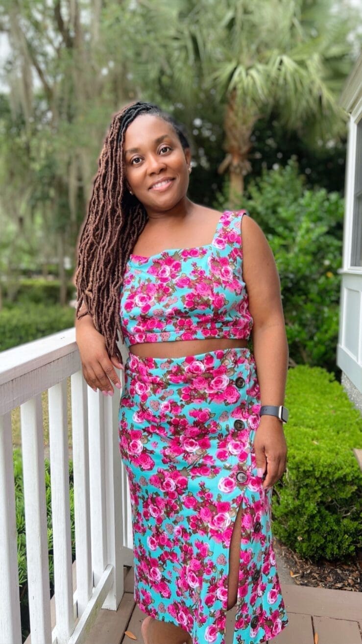 African American women standing outside on a white porch wearing Know Me Pattern 2013 in teal and blue knit foral fabric
