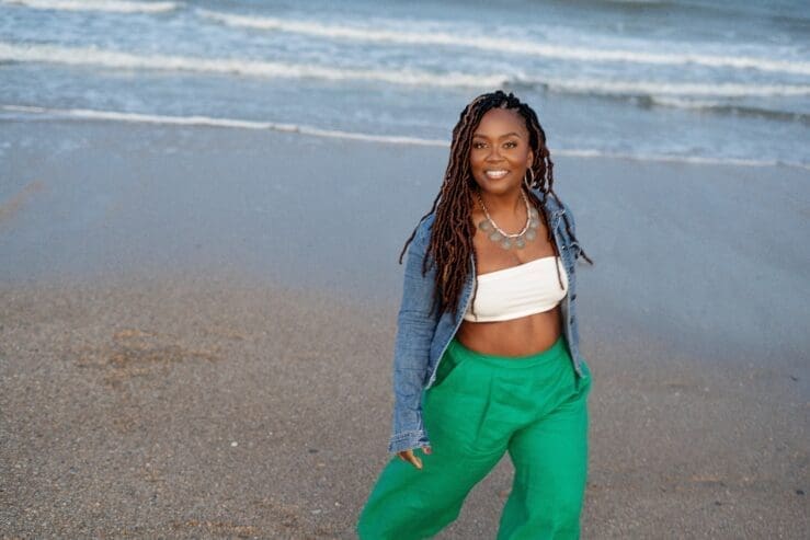 Black women standing on the sandy beach barefoot wearing kelly green simplicity 9235 pants