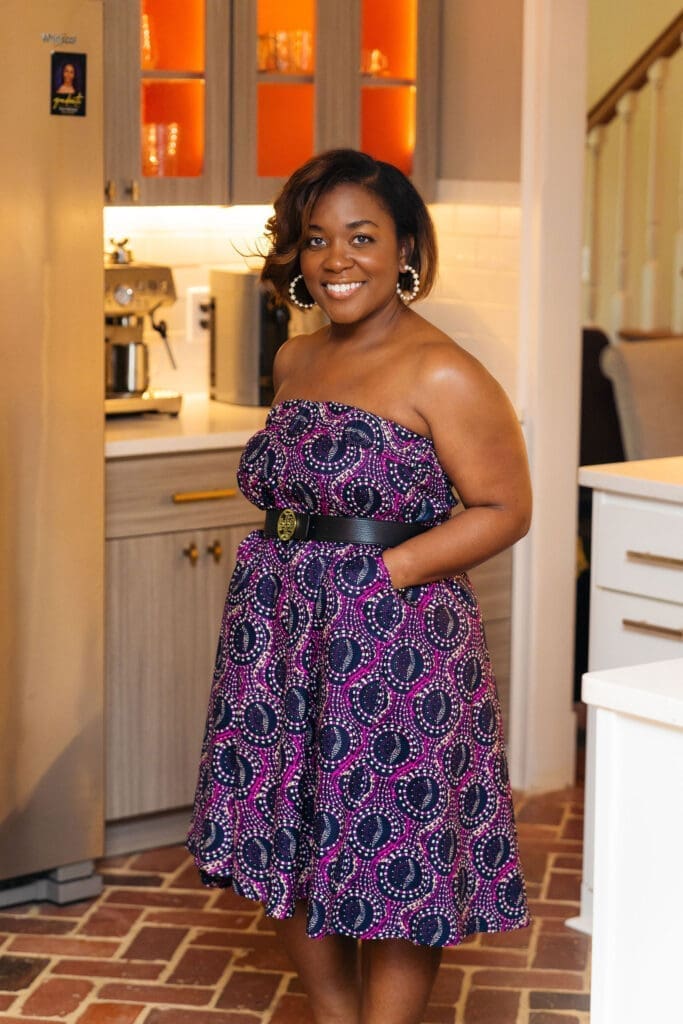 African American woman wearing Vogue 1871 with a tori Burch belt