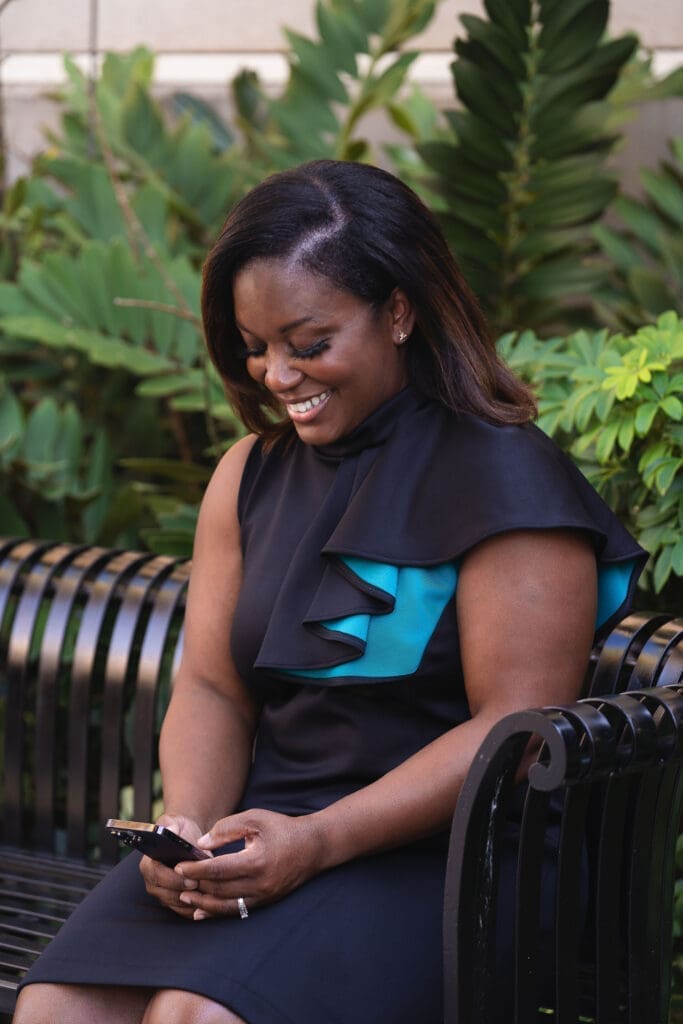African American woman wearing Vogue 1513 checking her phone