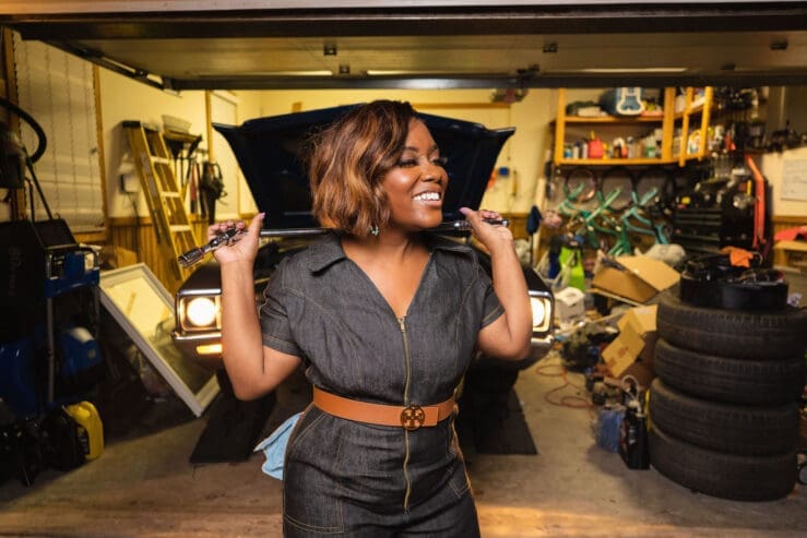 African American women holding car tool in front of car wearing McCalls7908
