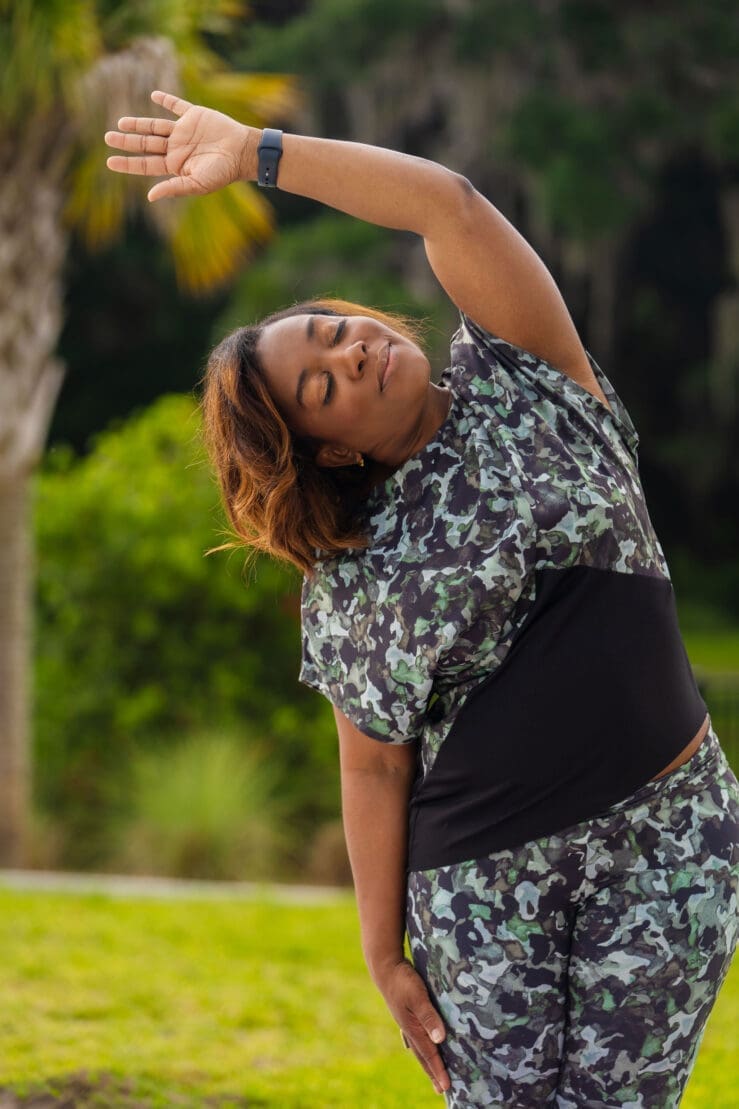 African American woman stretching with her eyes closed in McCalls 8244
