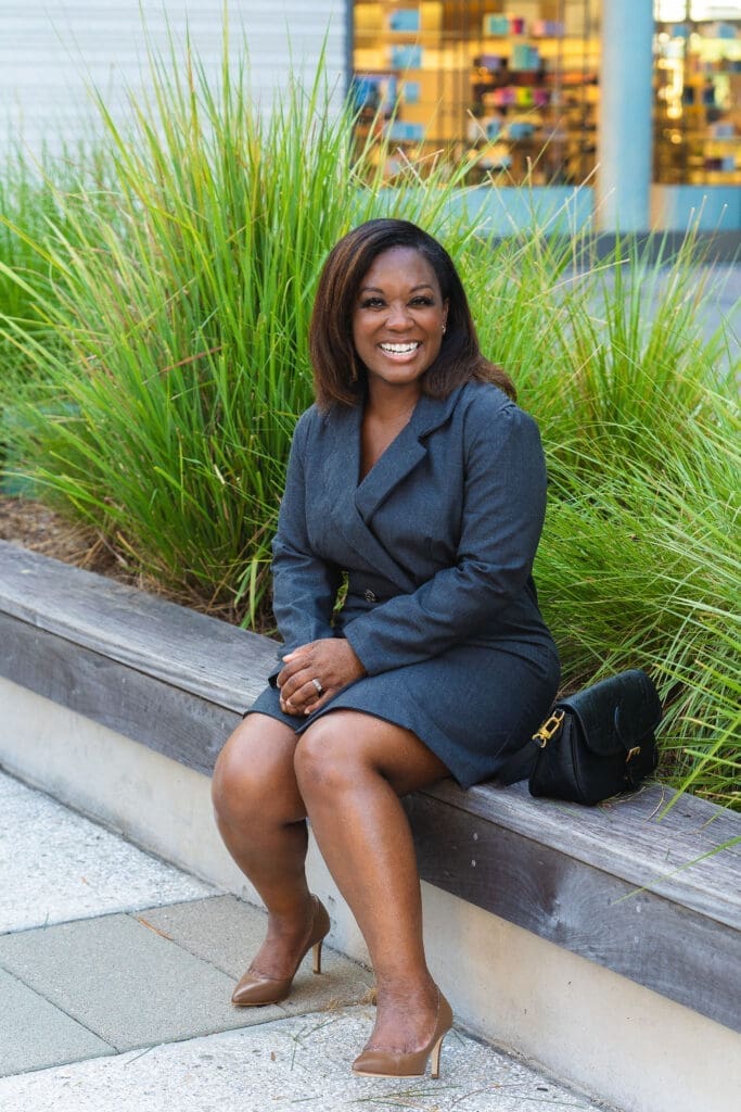 African American Women sitting wearing grey blazer dress McCalls 7997