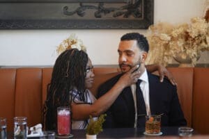 Couple at restaurant woman wearing Mccalls 8141 view C in silver satin