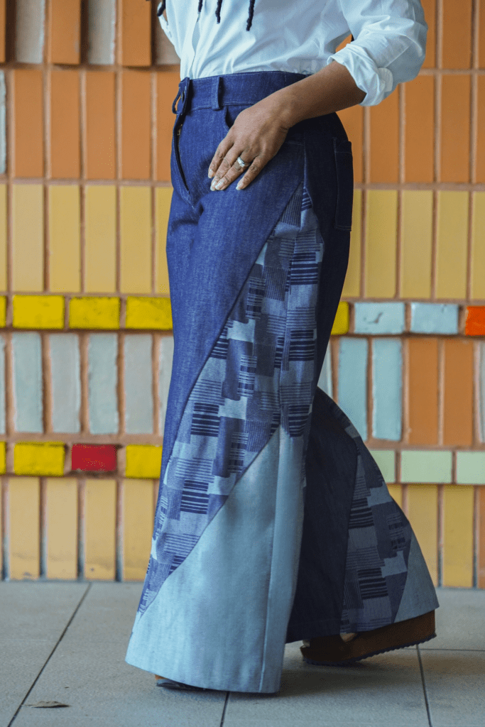 Shontae Buffington of Sewing for My Sanity in McCalls 8408 on a yellow art wall