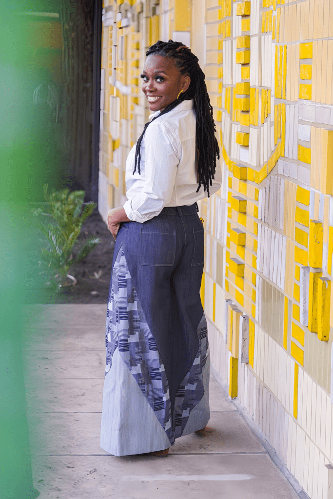 Shontae Buffington of Sewing for My Sanity in McCalls 8408 on a yellow art wall