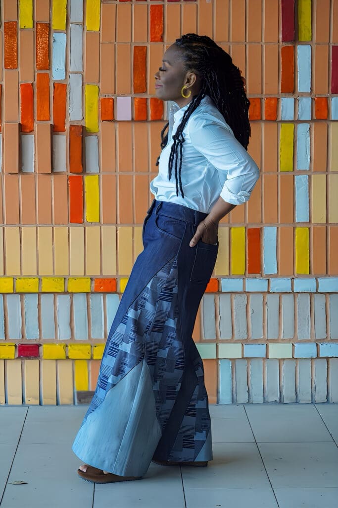 Shontae Buffington of Sewing for My Sanity in McCalls 8408 on a yellow art wall