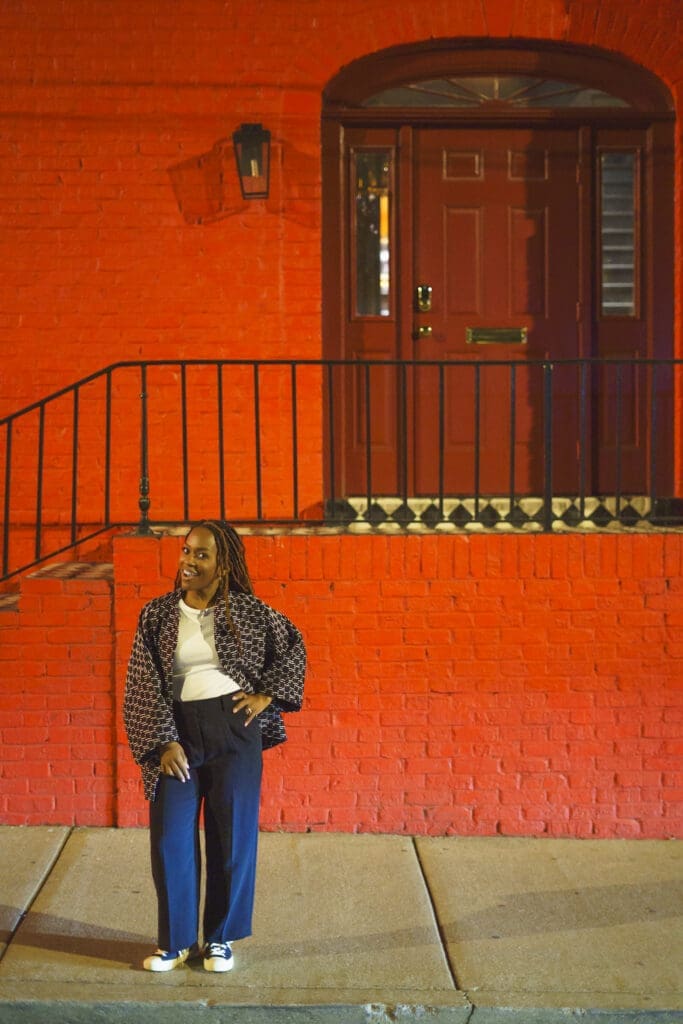 Nova coat behind red brick on the street