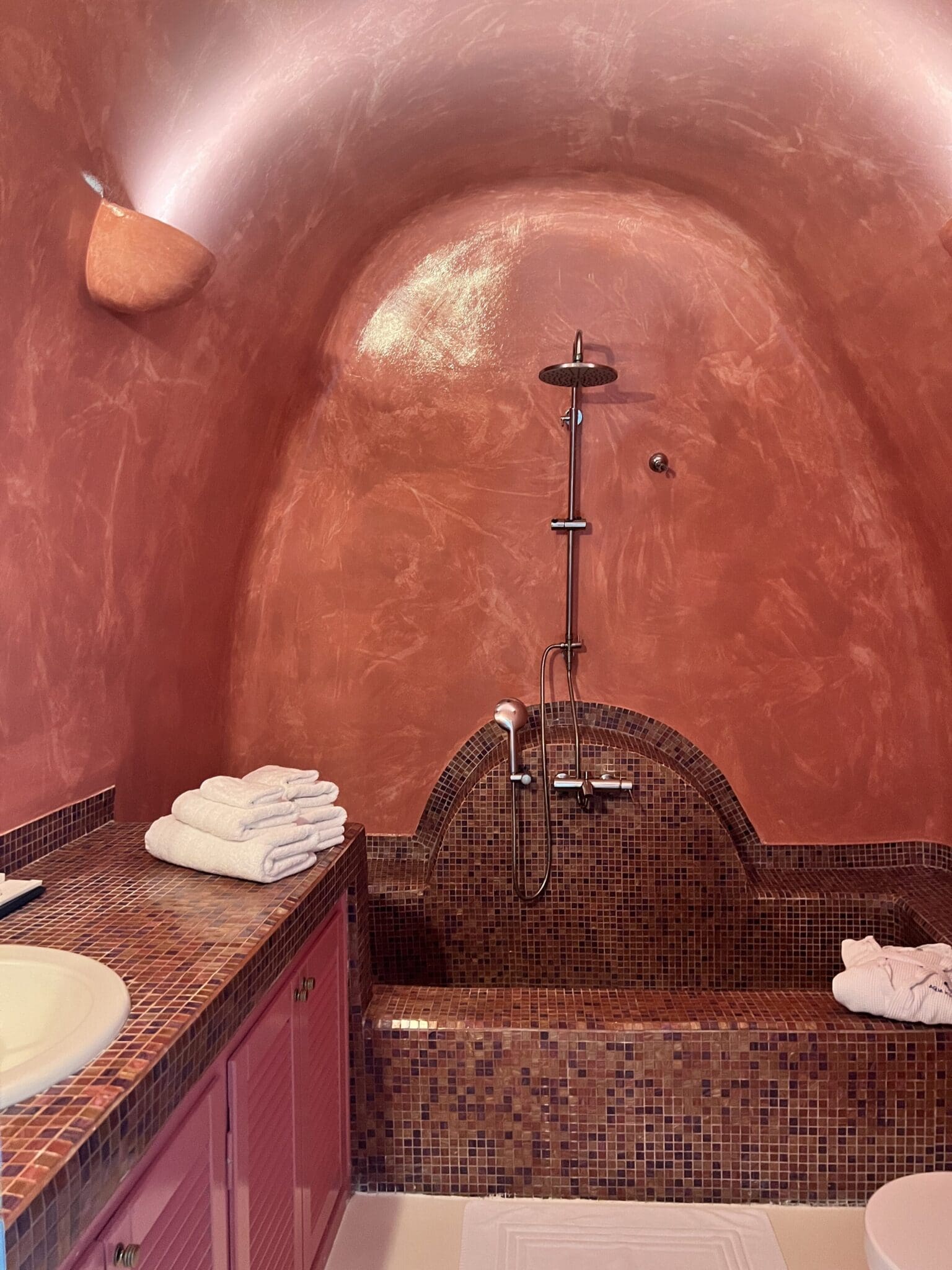 Terracotta spa bathroom in Greece for your travel shower essentials routine