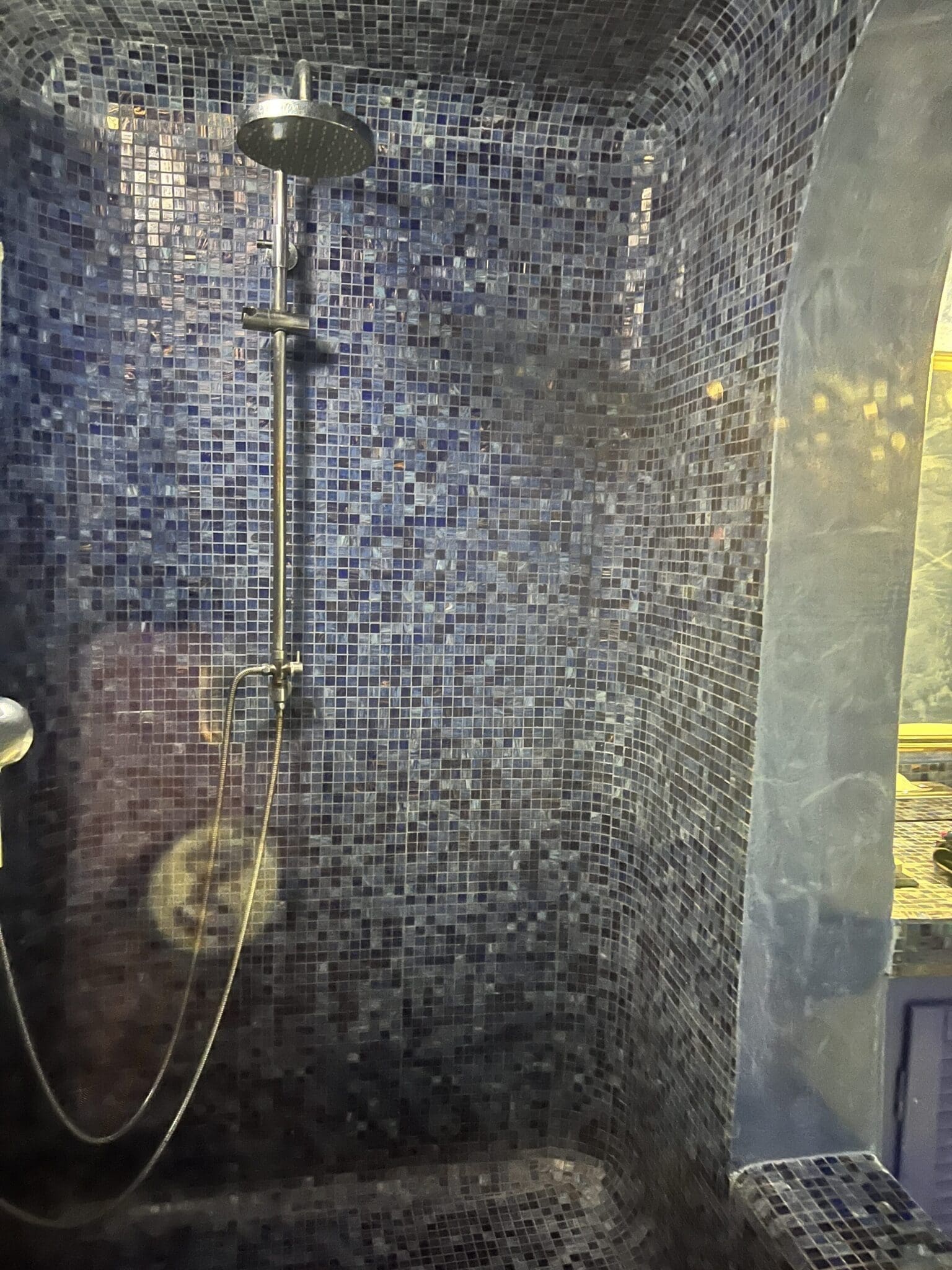 Tiled shower detail in Greece for the ultimate travel shower essentials ritual